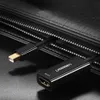 A close-up shot of a Ugreen Mini DisplayPort to HDMI adapter cable, partially tucked into a black zippered compartment. Voir les images du produit