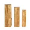 Three wooden pedestals of varying heights arranged side-by-side against a white background. Produktbild-Vorschau