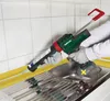 A person is using a cordless caulking gun to apply sealant around a kitchen sink. Produktbild-Vorschau