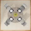 A top-down view of a round dining table set for four, with chairs arranged around it. Anteprima dell’immagine prodotto