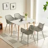 A dining set with a white table and four gray chairs arranged on a rug in a well-lit room. Náhled obrázku produktu