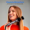 A woman is smiling while using a hair straightening brush on her hair. Produktbild-Vorschau