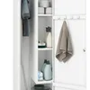 Interior view of a white storage cabinet, showing cleaning supplies and a towel. Náhled obrázku produktu