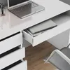 A close-up view of a white desk with a laptop and an open drawer containing books. Produktbild-Vorschau