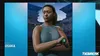 A digital rendering of a female tennis player, Naomi Osaka, in a tennis stadium setting, with game title and branding visible. Produktbild-Vorschau