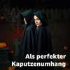 Two people in hooded cloaks stand in a spooky, outdoor setting with pumpkins and a spiderweb. Náhľad obrázku produktu