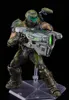 A figure of the Doom Slayer holding a large weapon, displayed on a clear stand against a black background. Náhľad obrázku produktu