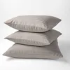 A stack of three beige striped pillows against a white background. Anteprima dell’immagine prodotto