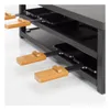 Close-up view of a raclette grill with multiple small pans and wooden handles. Produktbild-Vorschau