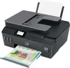 A gray HP Smart Tank Plus 655 Wireless AiO printer is shown from a slightly elevated front-left angle, with a printed document emerging from the output tray and a sheet of paper in the input tray. Podgląd zdjęcia produktu