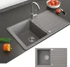 A kitchen sink with a faucet, a drying rack, and some vegetables on a countertop. Náhled obrázku produktu