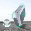 A white and gray electronic device with green glowing rings around it, suggesting movement or wireless charging, placed on a textured surface. Produktbild-Vorschau