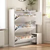 A white shoe cabinet with three flip-down drawers, filled with shoes, is shown in a room with a window and a door. Produktbild-Vorschau