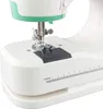 Close-up view of the base and needle area of a white and green sewing machine, showing a ruler marking in centimeters. Produktbild-Vorschau