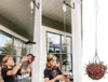 Two girls are shown on a porch, one filling a bird feeder and the other holding a flower basket, both attached to a retractable hanging system. Náhled obrázku produktu
