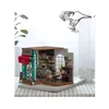 A miniature diorama of a cafe scene, displayed on a table with a striped tablecloth. Anteprima dell’immagine prodotto