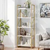 A white and gold bookshelf filled with decorative items and books, placed in a room next to a sofa and a plant. Produktbild-Vorschau