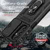 A black phone case with a ring holder and camera cover is shown in a dramatic, rocky outdoor setting. Produktbild-Vorschau