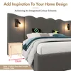 A bed with a large upholstered headboard, bedside table, and decorative elements. Produktbild-Vorschau