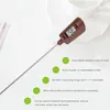 A digital food thermometer with its probe extended, placed on a white surface with some out-of-focus background elements. Podgląd zdjęcia produktu
