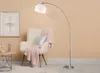 A modern living room scene with a floor lamp, armchair, and side table. Produktbild-Vorschau