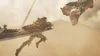 A warrior in armor is shown in mid-air, swinging a massive sword towards a dragon's head. Anteprima dell’immagine prodotto