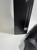 A close-up shot of a hair dryer brush and its packaging. Podgląd zdjęcia produktu