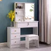 A white vanity table with a sliding mirror, drawers, and a stool, set against a teal wall with curtains in the background. Voir les images du produit