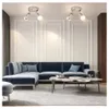 A modern living room with a sectional sofa, coffee table, and ceiling lights. Produktbild-Vorschau