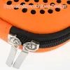 A close-up of an orange case with a black zipper and two silver zipper pulls. Produktbild-Vorschau