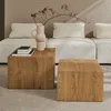 Two wooden cube-shaped coffee tables are placed in front of a sectional sofa with beige cushions. A vase with branches is on the left table. Produktbild-Vorschau