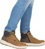 A person wearing blue jeans and brown high-top boots. Produktbild-Vorschau