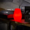A red LED light sits on a shelf next to a turntable and audio equipment. Produktbild-Vorschau