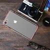 A flat lay of an iPhone case, a vintage camera, a wallet with credit cards, a Nikon lens cap, and glasses on a wooden surface. Produktbild-Vorschau