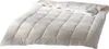 A white down comforter is laid out on a white background. Produktbild-Vorschau