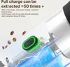 Close-up of a portable coffee machine's power button and battery, with coffee beans falling in the background. Podgląd zdjęcia produktu