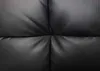 A close-up view of black faux leather upholstery with tufted stitching. Produktbild-Vorschau
