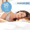 A woman is sleeping peacefully on a bed. There is text and a circle with numbers and text on the image. Produktbild-Vorschau