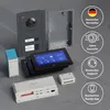 A collection of components for a GOLIATH door intercom system, including an outdoor unit, indoor monitors, and control units, arranged on a grey surface. Produktbild-Vorschau