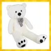 A large, white teddy bear with a brown and white checkered bow tie is shown sitting down. Anteprima dell’immagine prodotto