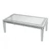 A rectangular glass coffee table with a crushed diamond inlay around the edges and four tapered glass legs, presented against a white background. Anteprima dell’immagine prodotto
