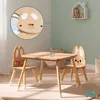 A children's wooden table and chairs set with a bunny design, set in a nursery or playroom. Produktbild-Vorschau