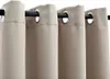 A close-up view of beige grommet curtains hanging on a black curtain rod. Náhled obrázku produktu