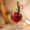 A festive drink with cranberries, rosemary, and a candy cane. Náhľad obrázku produktu