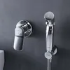 A close-up shot of a modern chrome bidet faucet and hand sprayer mounted on a gray wall. Produktbild-Vorschau