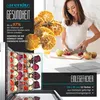 A woman is preparing food in a kitchen, with a food dehydrator visible in the foreground. Produktbild-Vorschau