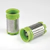 Two cylindrical grater attachments with green plastic rims and silver metal bodies with perforations, set against a plain background. Voir les images du produit