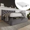 A grey upholstered bed frame with a mattress and storage drawers is shown in a bedroom setting. Produktbild-Vorschau