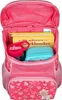 An open pink kindergarten backpack filled with a book, a water bottle, and a lunchbox. Anteprima dell’immagine prodotto