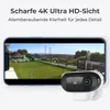 A smartphone displaying a live feed from a security camera, with the camera itself shown in the foreground. Produktbild-Vorschau